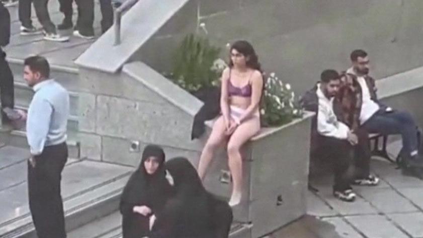 Iranian woman taking clothes off at university